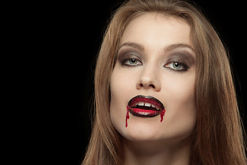 Image showing Close-up portrait of a smiling gothic vampire woman