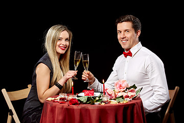 Image showing Portrait Of Romantic Couple Toasting white Wine At Dinner
