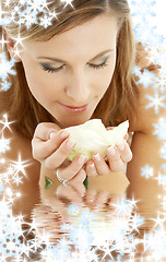 Image showing happy girl with white rose and snowflakes in water