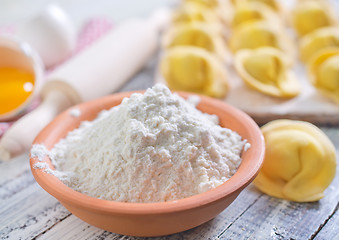 Image showing flour and raw pelmeni