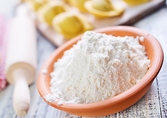 Image showing flour and raw pelmeni