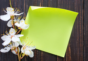 Image showing flowers and paper on wooden background