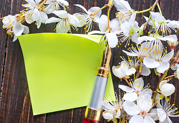 Image showing flowers and paper on wooden background