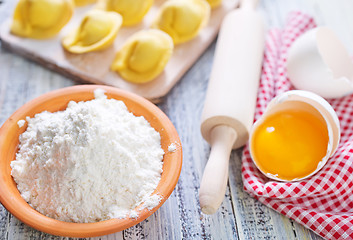 Image showing flour and raw pelmeni