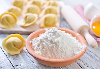 Image showing flour and raw pelmeni