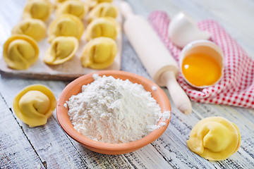 Image showing flour and raw pelmeni