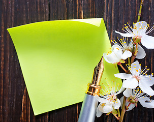 Image showing flowers and paper on wooden background