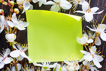 Image showing flowers and paper on wooden background