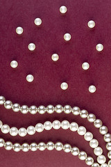 Image showing Silver and White pearls necklace on dark red 