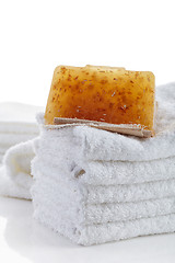 Image showing stack of towels and natural soap bar