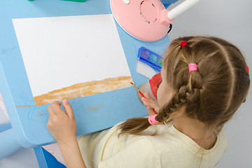 Image showing Girl draws on the ground below