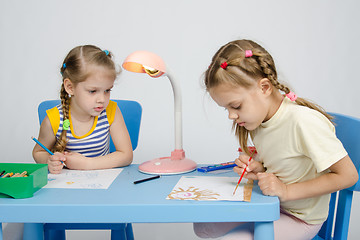 Image showing Girl watching sister draws paints