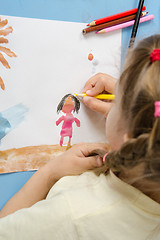 Image showing Girl draws a pencil on drawing painted colors