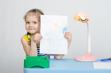 Image showing Four-year girl shows new picture