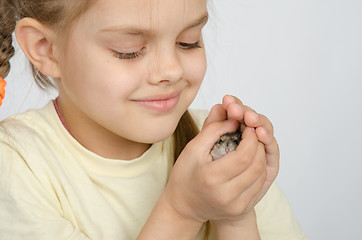 Image showing Girl holding a hamster