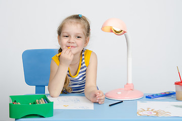 Image showing Four-year girl conceived and put pencil to his lips