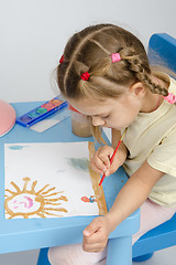 Image showing Six year old girl draws a paint something in the picture