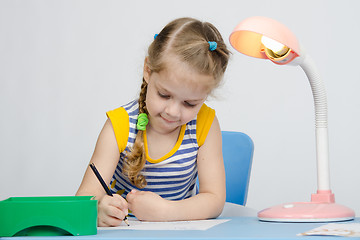 Image showing The girl loves to draw with pencils