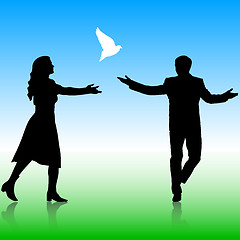 Image showing Silhouettes girl and guy released doves into the sky. 