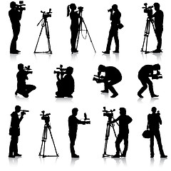 Image showing Cameraman with video camera. Silhouettes on white background. 