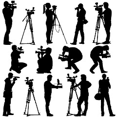 Image showing Cameraman with video camera. Silhouettes on white background. 