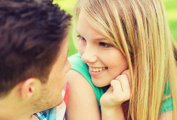 Image showing smiling couple looking at each other in park