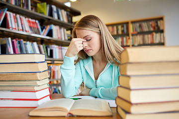 Image showing bored student or young woman with books in library