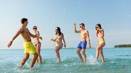 Image showing happy friends having fun on summer beach