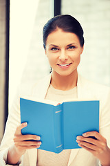 Image showing happy and smiling woman with book