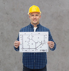 Image showing smiling male builder in helmet with blueprint