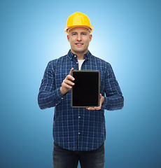 Image showing smiling male builder in helmet with tablet pc