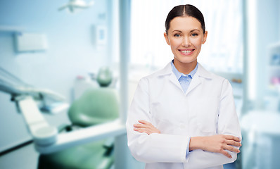 Image showing happy young female dentist with tools