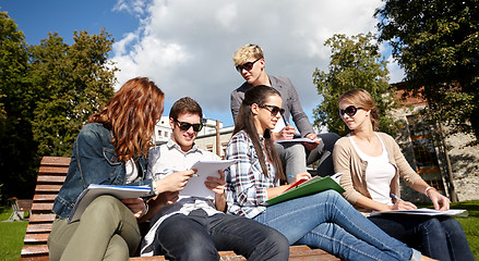 Image showing group of happy students with notebooks at campus