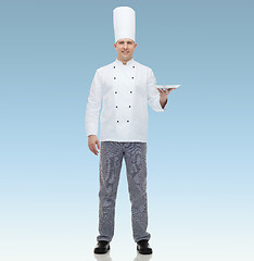 Image showing happy male chef cook showing empty plate