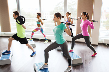 Image showing group of people exercising with barbell in gym