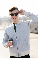 Image showing smiling young man or boy drinking coffee