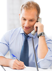 Image showing handsome businessman talking on the phone