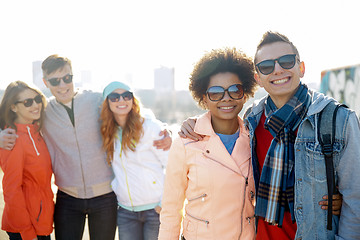 Image showing happy teenage friends in shades talking on street