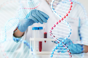 Image showing close up of scientist with tube making test in lab