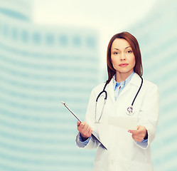 Image showing calm female doctor with clipboard