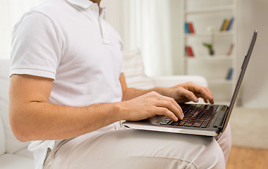 Image showing close up of man working with laptop at home