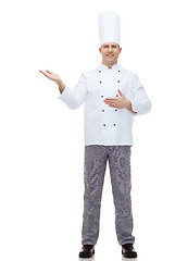 Image showing happy male chef cook inviting