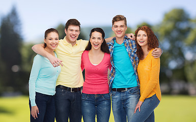 Image showing group of smiling teenagers over green park