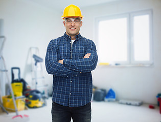 Image showing smiling male builder or manual worker in helmet