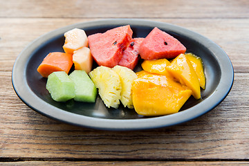 Image showing plate of fresh juicy fruits at asian restaurant