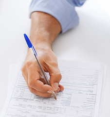 Image showing man filling tax form