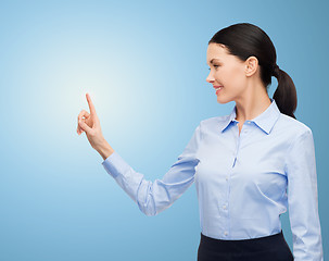 Image showing businesswoman touching something imaginary