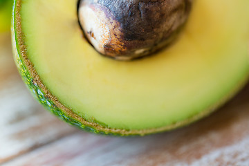 Image showing close up of ripe avocado with bone on table