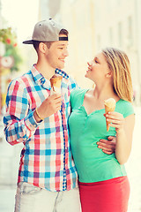 Image showing smiling couple with ice-cream in city