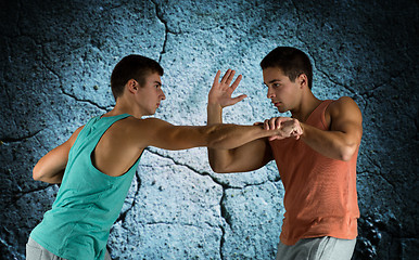 Image showing young men fighting hand-to-hand